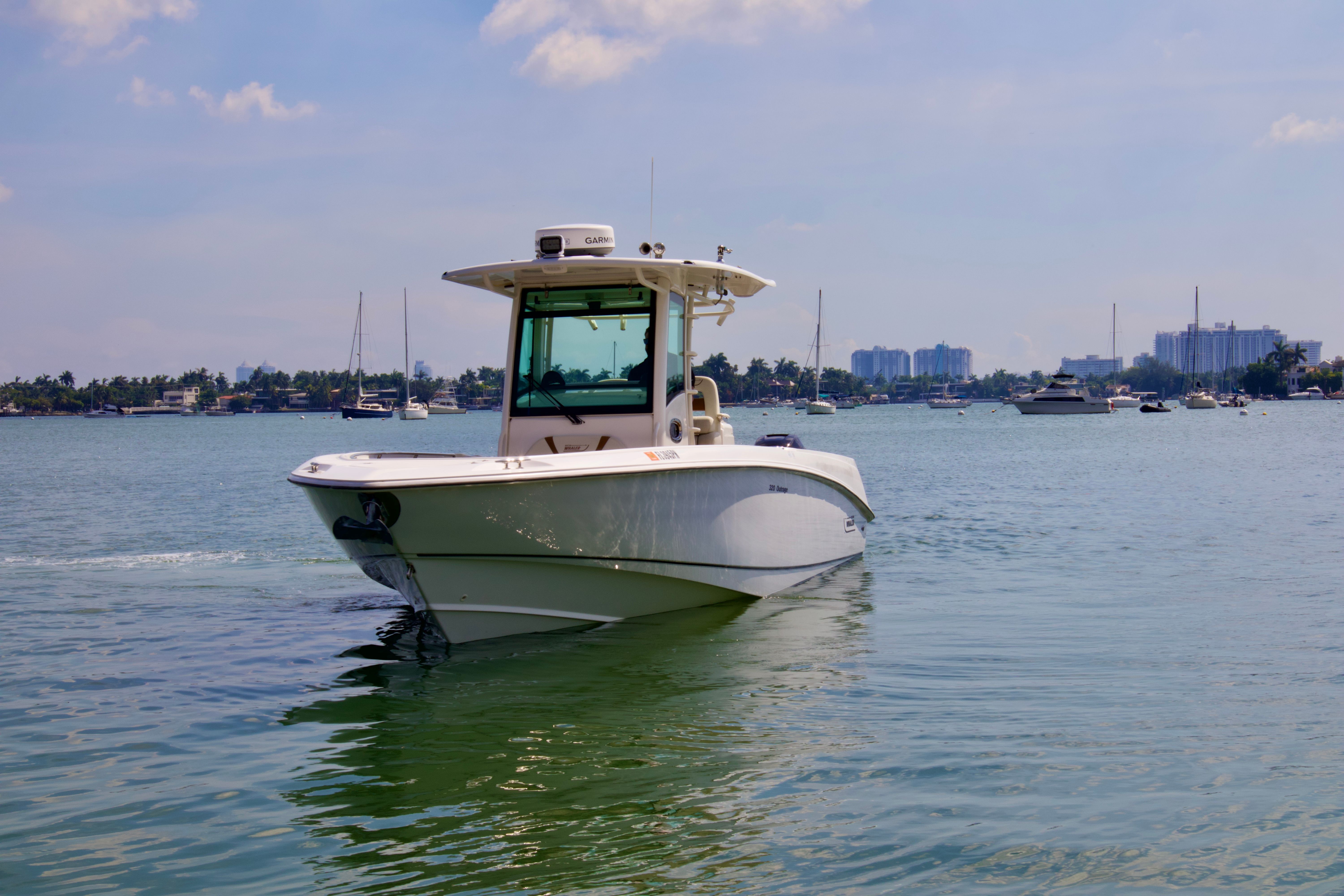 Boston Whaler 320 Outrage 2013 Boston Whaler 320 Outrage boat cruising on a calm waterway.