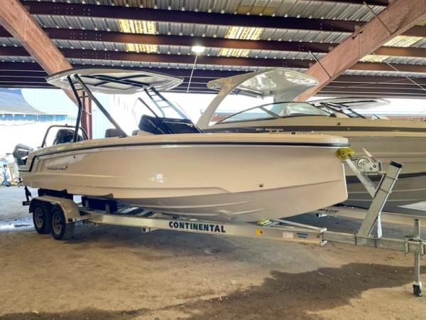 Axopar 22 T-Top 2023 Axopar 22 T-Top boat on a Continental trailer in a covered storage area.