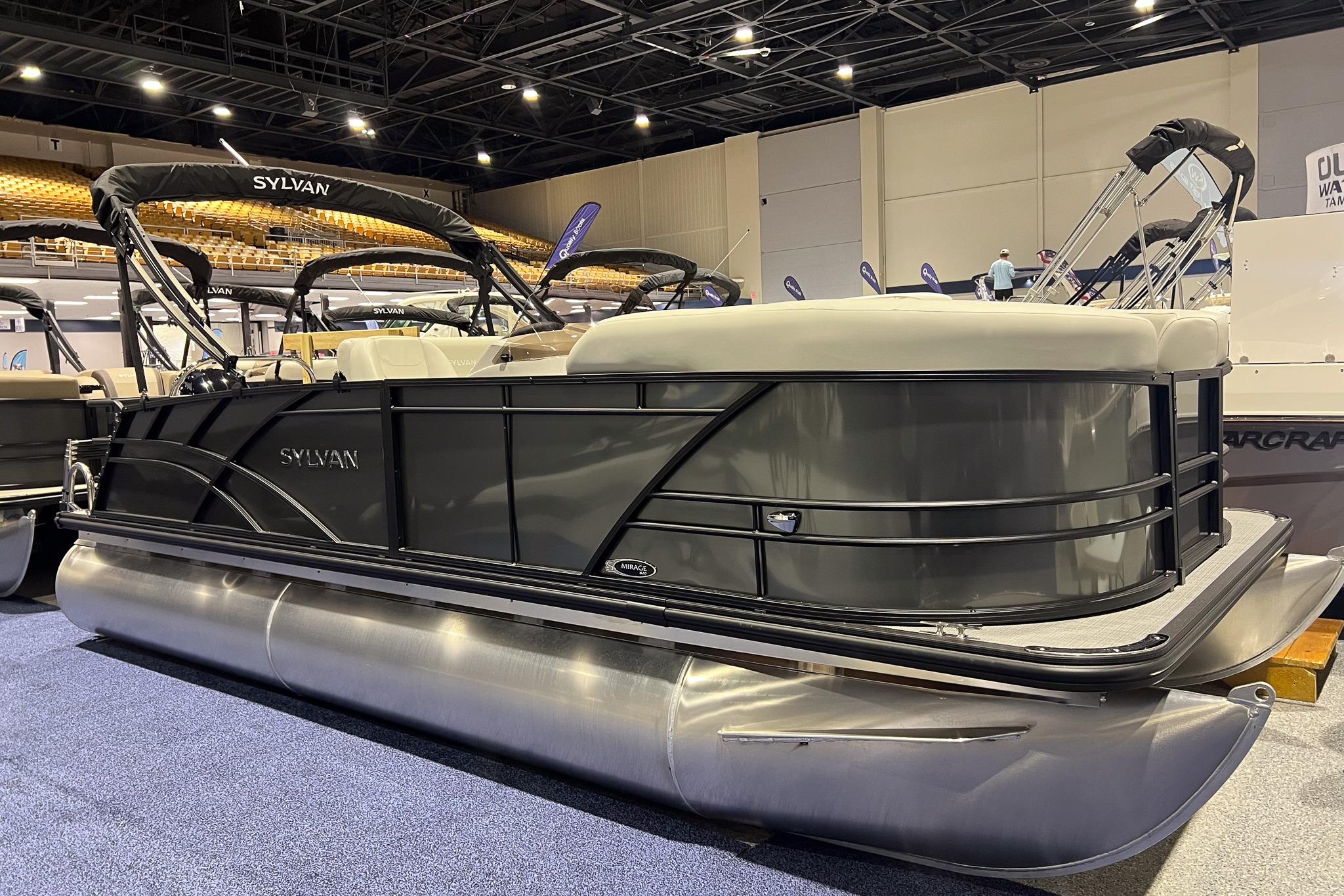 Sylvan Mirage 820 CLZ DH 2026 Sylvan Mirage 820 CLZ DH pontoon boat displayed indoors at a boat show.