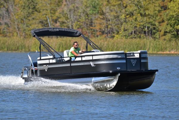 Viaggio DM18U 2023 Viaggio DM18U pontoon boat cruising on a lake with lush greenery in the background.