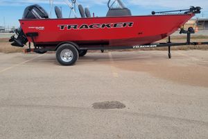 Tracker Pro Guide V-16 WT 2026 Tracker Pro Guide V-16 WT boat on trailer, red exterior, parked outdoors.