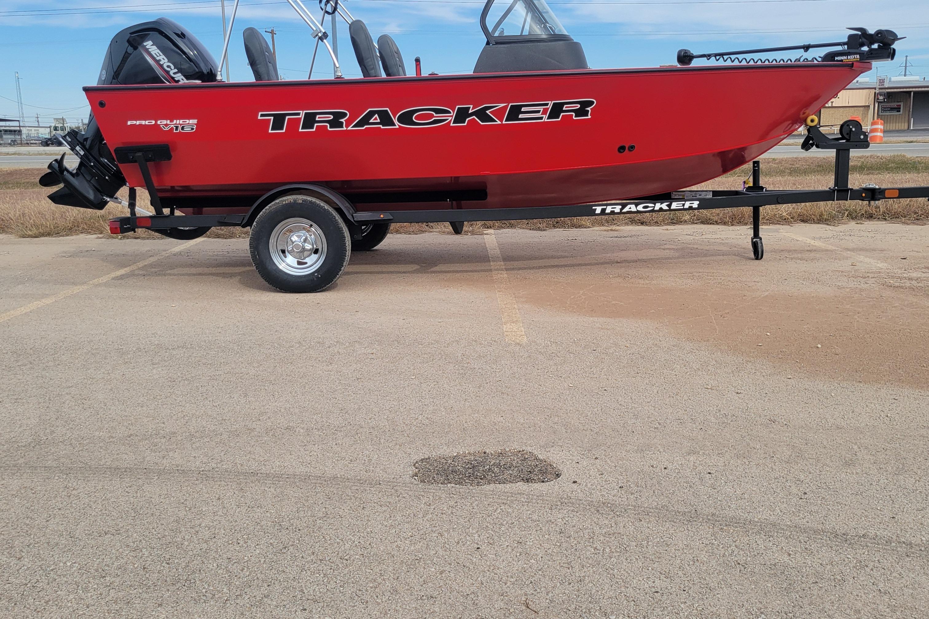Tracker Pro Guide V-16 WT 2026 Tracker Pro Guide V-16 WT boat on trailer, red exterior, parked outdoors.
