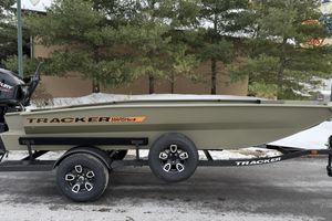 Tracker Grizzly 1756 T Marsh 2026 Tracker Grizzly 1756 T Marsh boat on trailer, outdoors with trees in background.