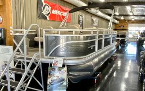 Sun Tracker Fishin' Barge 20 DLX 2024 Sun Tracker Fishin' Barge 20 DLX pontoon boat displayed indoors.