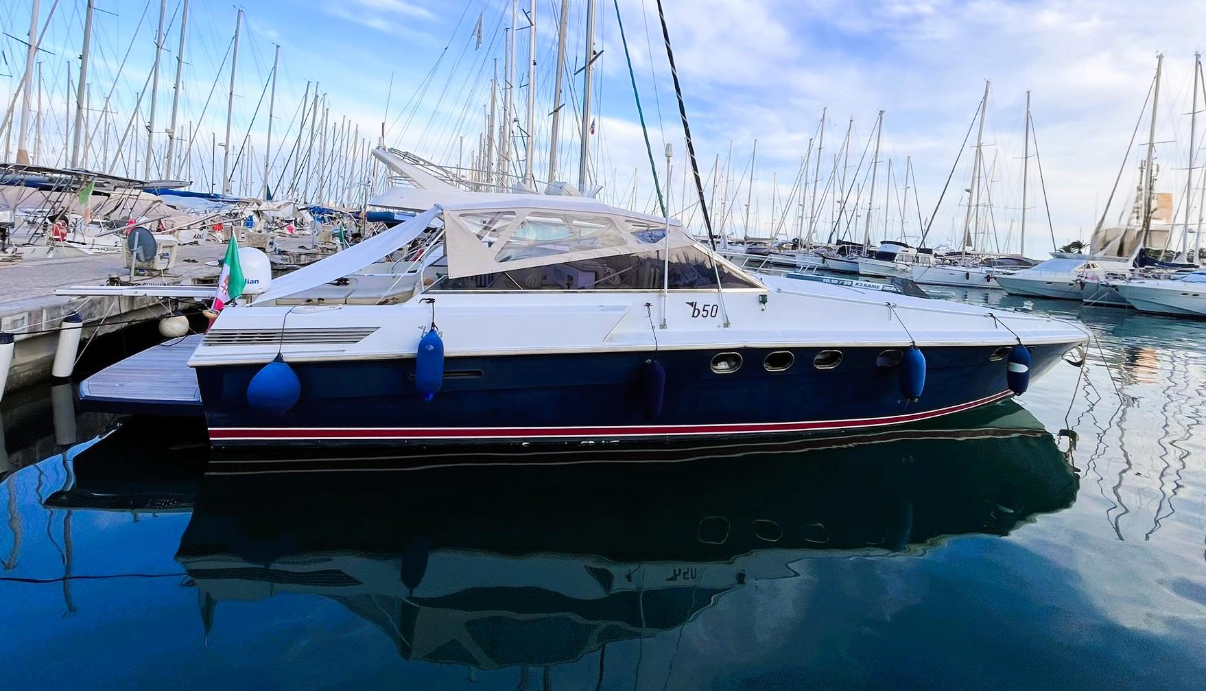 Baia B50 1988 Baia B50 yacht docked in a marina, surrounded by sailboats.