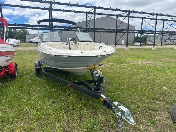 Stingray 191 DC 2022 Stingray 191 DC boat on trailer, parked on grass, with overcast sky.