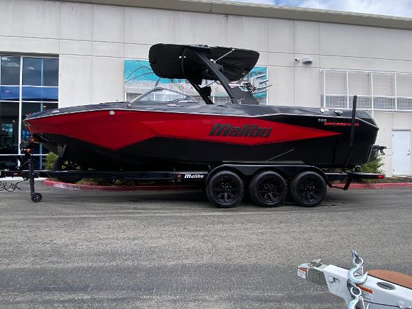 Malibu Wakesetter 25 LSV 2025 Malibu Wakesetter 25 LSV boat in red and black on a trailer.