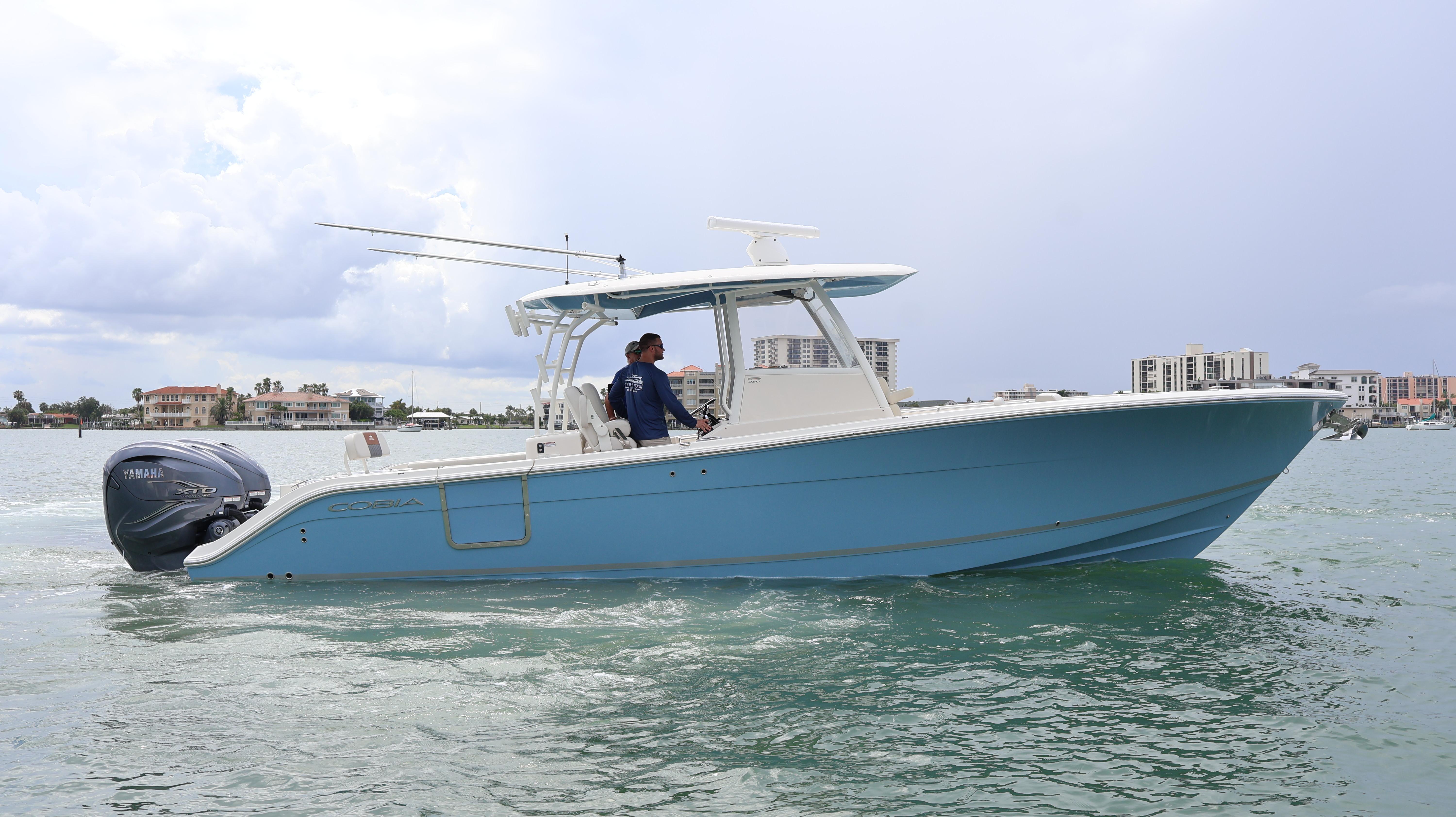 Cobia 350 Center Console 2020 Cobia 350 Center Console boat cruising on water with cityscape background.
