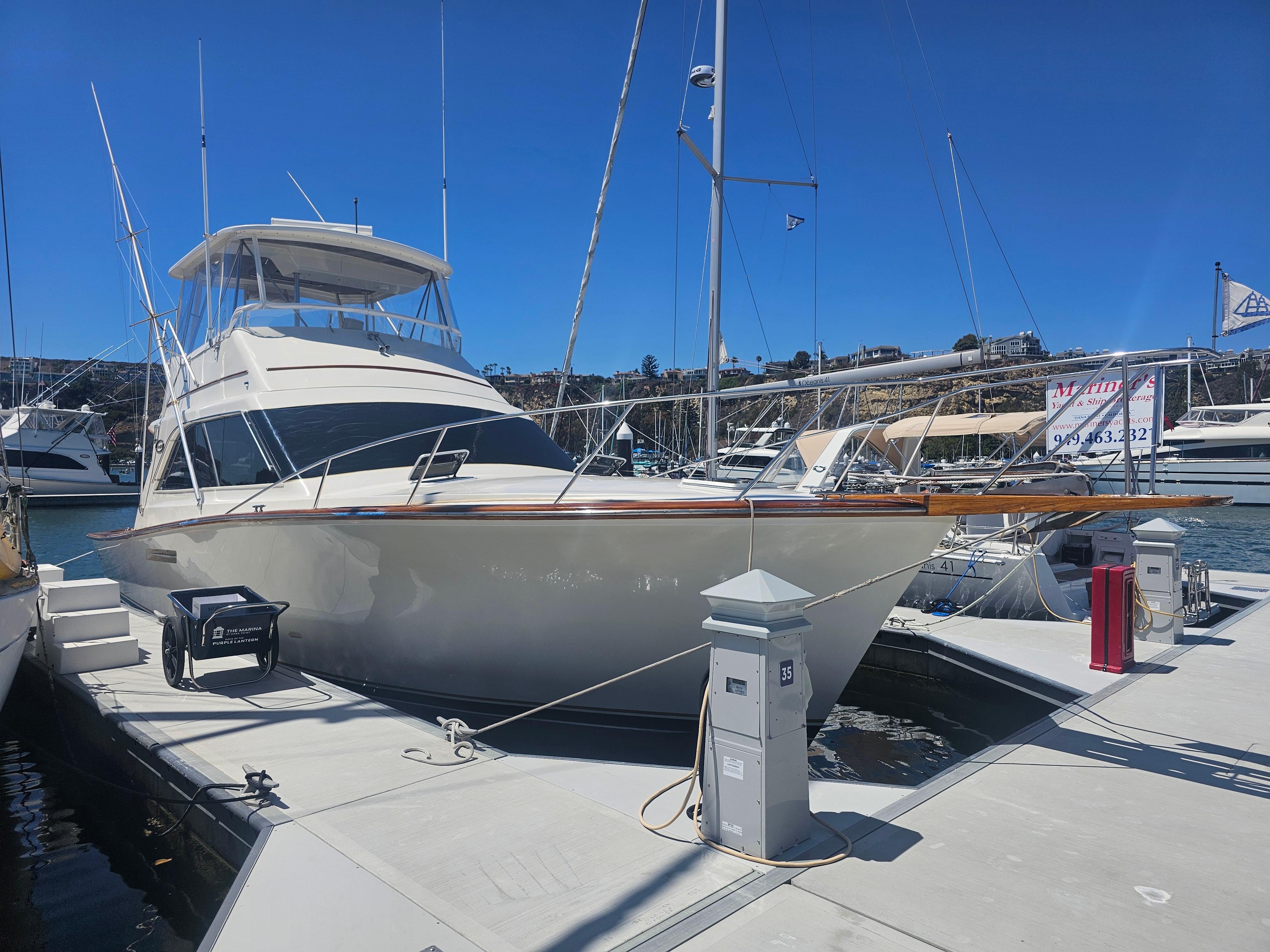 Ocean Yachts 44 Super Sport 1990 Ocean Yachts 44 Super Sport docked at marina under clear blue sky.