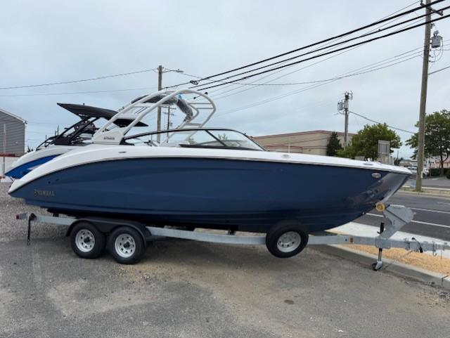 Yamaha Boats 252S 2025 Yamaha Boats 252S on trailer, blue hull, parked outdoors.