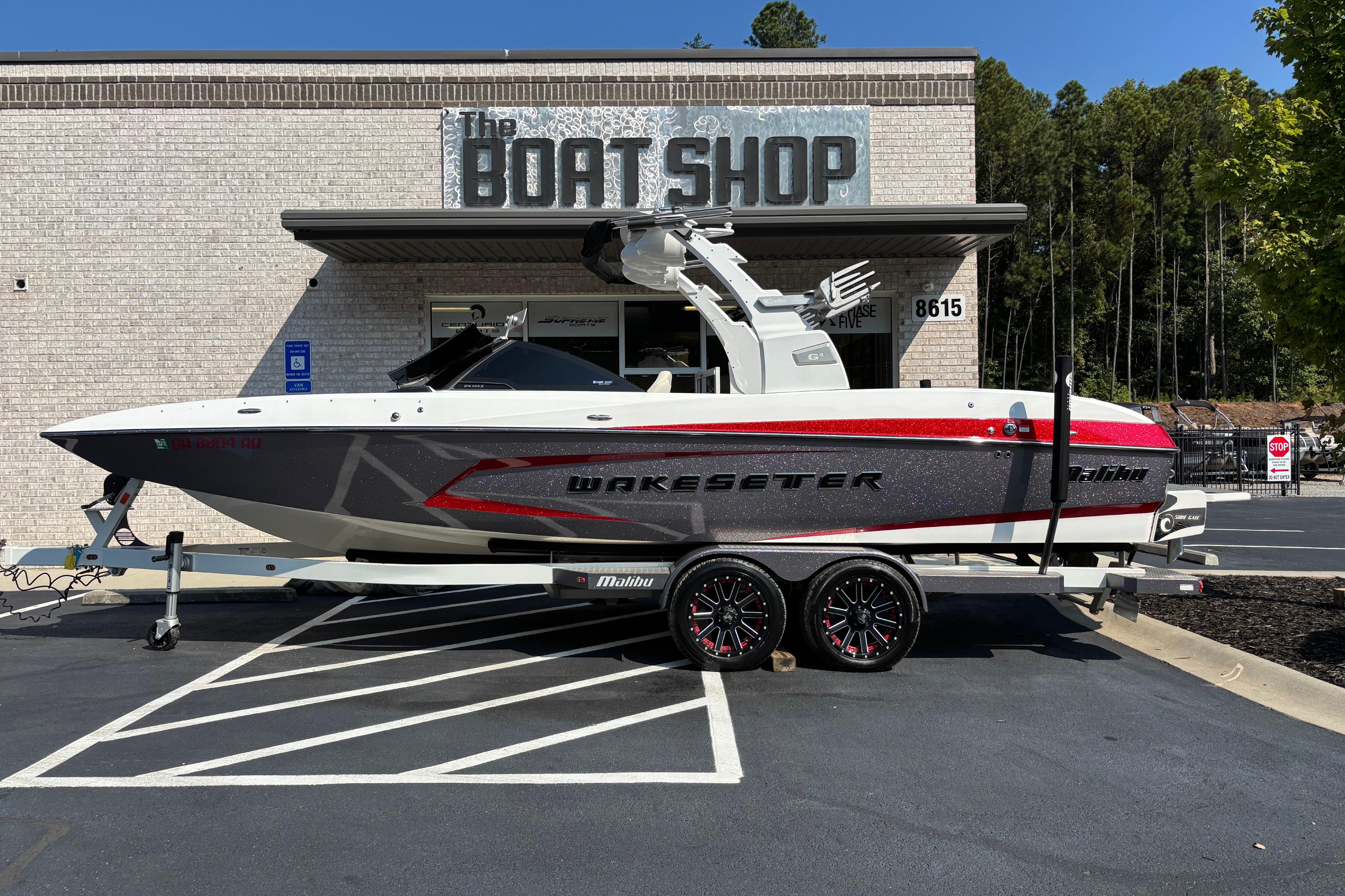 Malibu Wakesetter 24 MXZ 2016 Malibu Wakesetter 24 MXZ boat on trailer outside The Boat Shop.