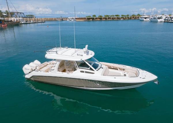 Boston Whaler 350 Realm 2021 Boston Whaler 350 Realm boat in a marina, calm blue waters, clear sky.