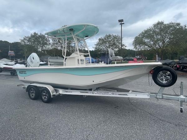 Carolina Skiff 23LS 2025 Carolina Skiff 23LS boat on trailer, parked outdoors under cloudy sky.