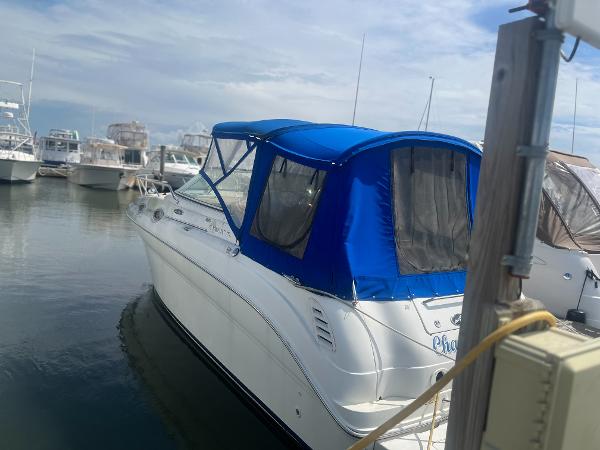 Sea Ray 260 Sundancer 2002 Sea Ray 260 Sundancer with blue canopy docked at marina.
