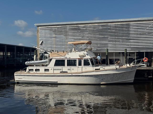 Grand Banks 46 Classic Galley Up 2002 Grand Banks 46 Classic Galley Up Custom yacht docked by a marina.