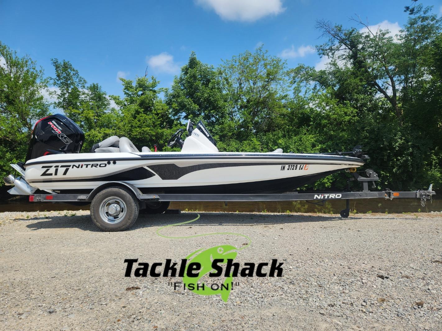Nitro Z17 2022 Nitro Z17 boat on trailer, parked outdoors with trees in background.
