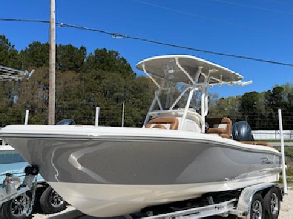 Pioneer 202 Islander 2025 Pioneer 202 Islander boat on trailer, parked outdoors under clear blue sky.