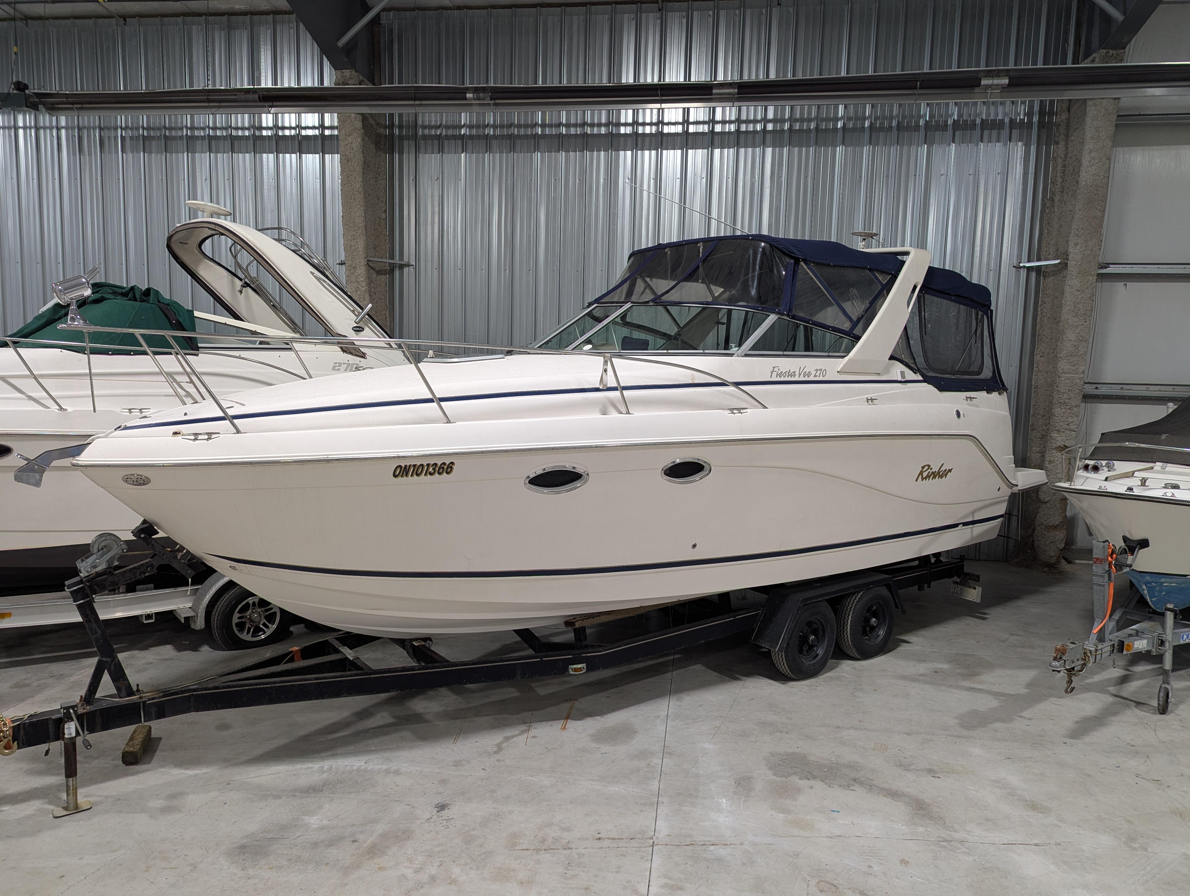 Rinker Fiesta Vee 270 2003 Rinker Fiesta Vee 270 boat on trailer in storage facility.