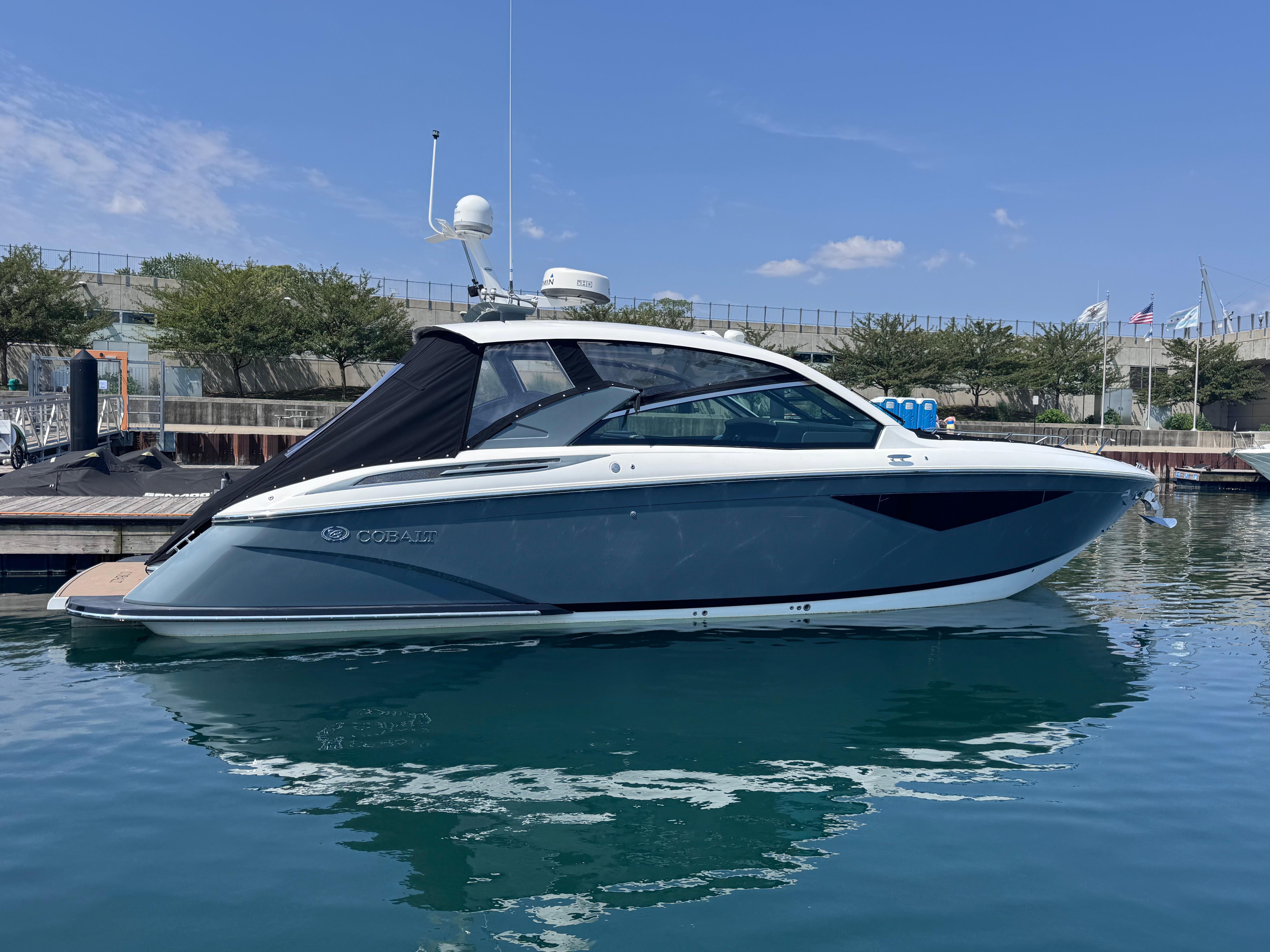 Cobalt A36 2018 Cobalt A36 boat docked in a marina under a clear blue sky.