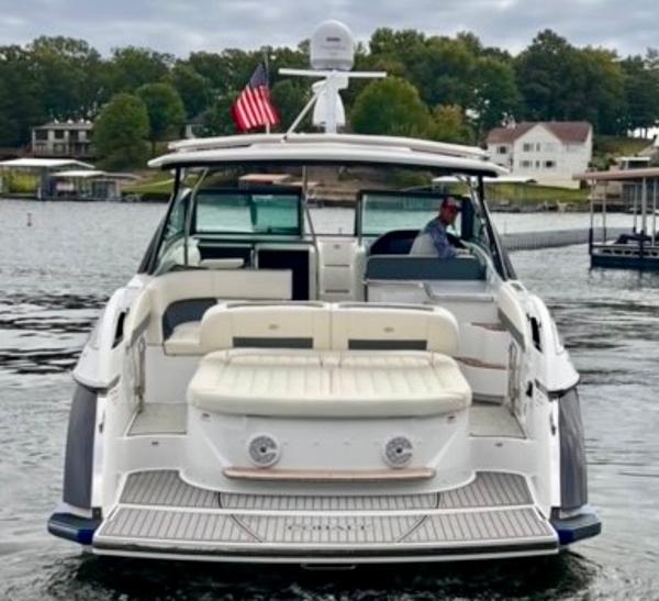 Cobalt A40 2017 Cobalt A40 boat on a lake with American flag, rear view.