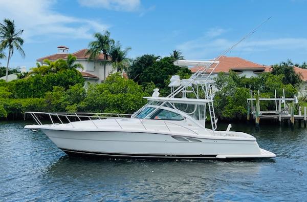 Tiara Yachts 3800 Open 2003 Tiara Yachts 3800 Open cruising on a scenic waterway with lush greenery.