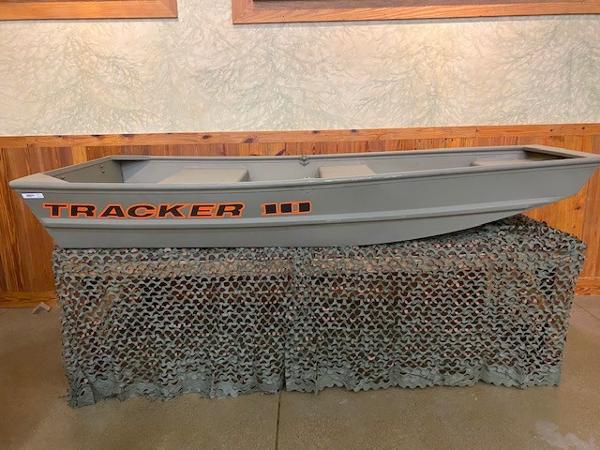 Tracker Grizzly 1036 Utility 2025 Tracker Grizzly 1036 Utility boat displayed indoors on a camo net.