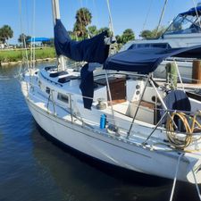 Cheoy Lee Sloop 1984 Cheoy Lee Sloop sailboat docked in a marina, featuring blue covers and clear skies.