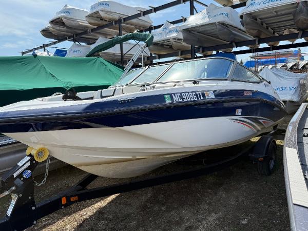 Yamaha Boats SX190 2016 Yamaha SX190 boat on trailer, parked outdoors with other boats.