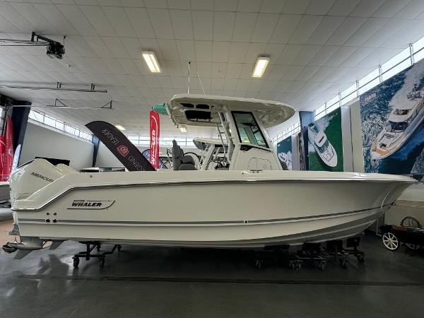 Boston Whaler 250 Outrage 2025 Boston Whaler 250 Outrage boat displayed in a showroom.