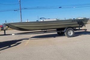Tracker Grizzly 1860 Utility 2025 Tracker Grizzly 1860 Utility boat on trailer in parking lot.