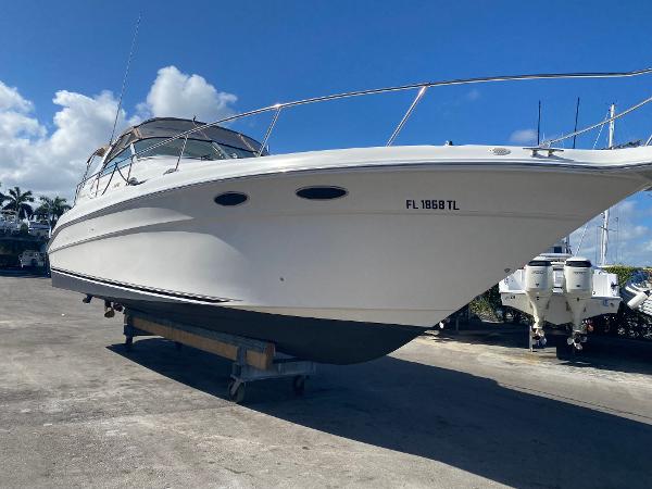 Sea Ray 330 Sundancer 1997 Sea Ray 330 Sundancer boat on dry dock under clear blue sky.