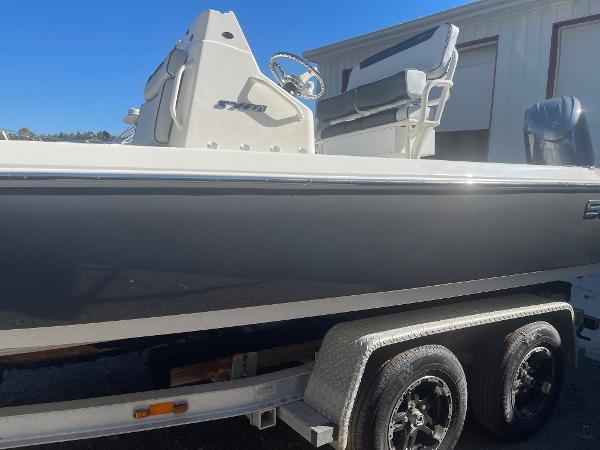 Skeeter SX221 2025 Skeeter SX221 boat on trailer, side view, outdoors, clear sky.