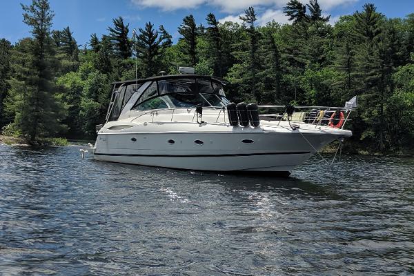 Cruisers Yachts 3970 Express 2003 Cruisers Yachts 3970 Express on a serene lake with forested background.