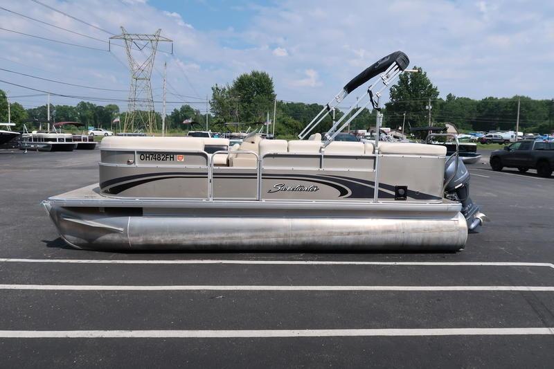 Sweetwater 200 Classic 2012 Sweetwater 200 Classic pontoon boat parked in a lot under a blue sky.