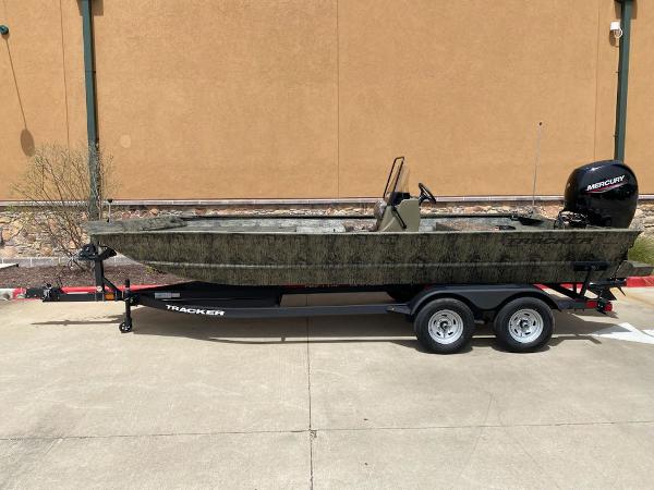 Tracker Grizzly 2072 CC 2025 Tracker Grizzly 2072 CC boat on trailer, camo design, parked outdoors.