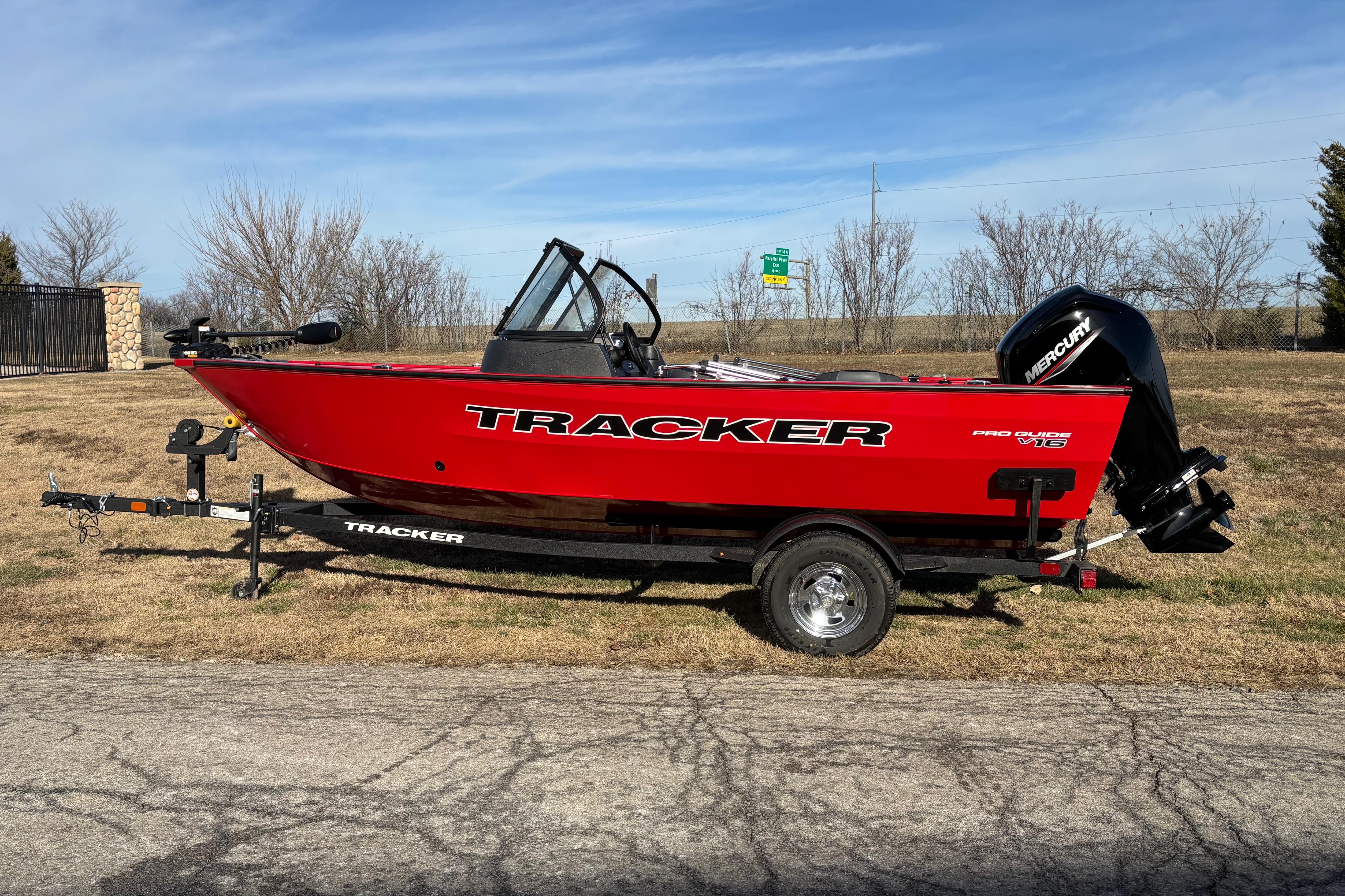 Tracker Pro Guide V-16 WT 2026 Tracker Pro Guide V-16 WT boat on trailer, red exterior, parked outdoors.