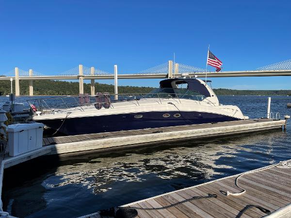 Sea Ray 420 Sundancer 2003 Sea Ray 420 Sundancer yacht docked by a bridge on a sunny day.