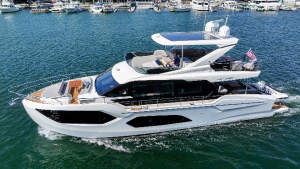Absolute 60 Fly Co Ownership 2024 Absolute 60 Fly Co Ownership yacht cruising in a marina, showcasing sleek design and luxury.