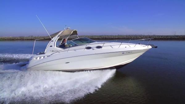 Sea Ray 320 Sundancer 2002 Sea Ray 320 Sundancer cruising on open water, side view.