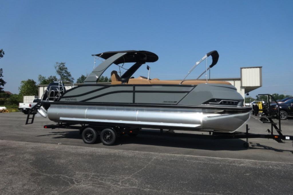 Harris Grand Mariner 250 2026 Harris Grand Mariner 250 pontoon boat on trailer, parked outdoors.