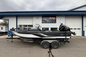 Crestliner 2050 Fish Hawk 2025 Crestliner 2050 Fish Hawk boat on trailer outside marine dealership.