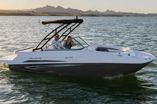 Hurricane SunDeck 187 IO 2022 Hurricane SunDeck 187 IO boat cruising on a lake at sunset.