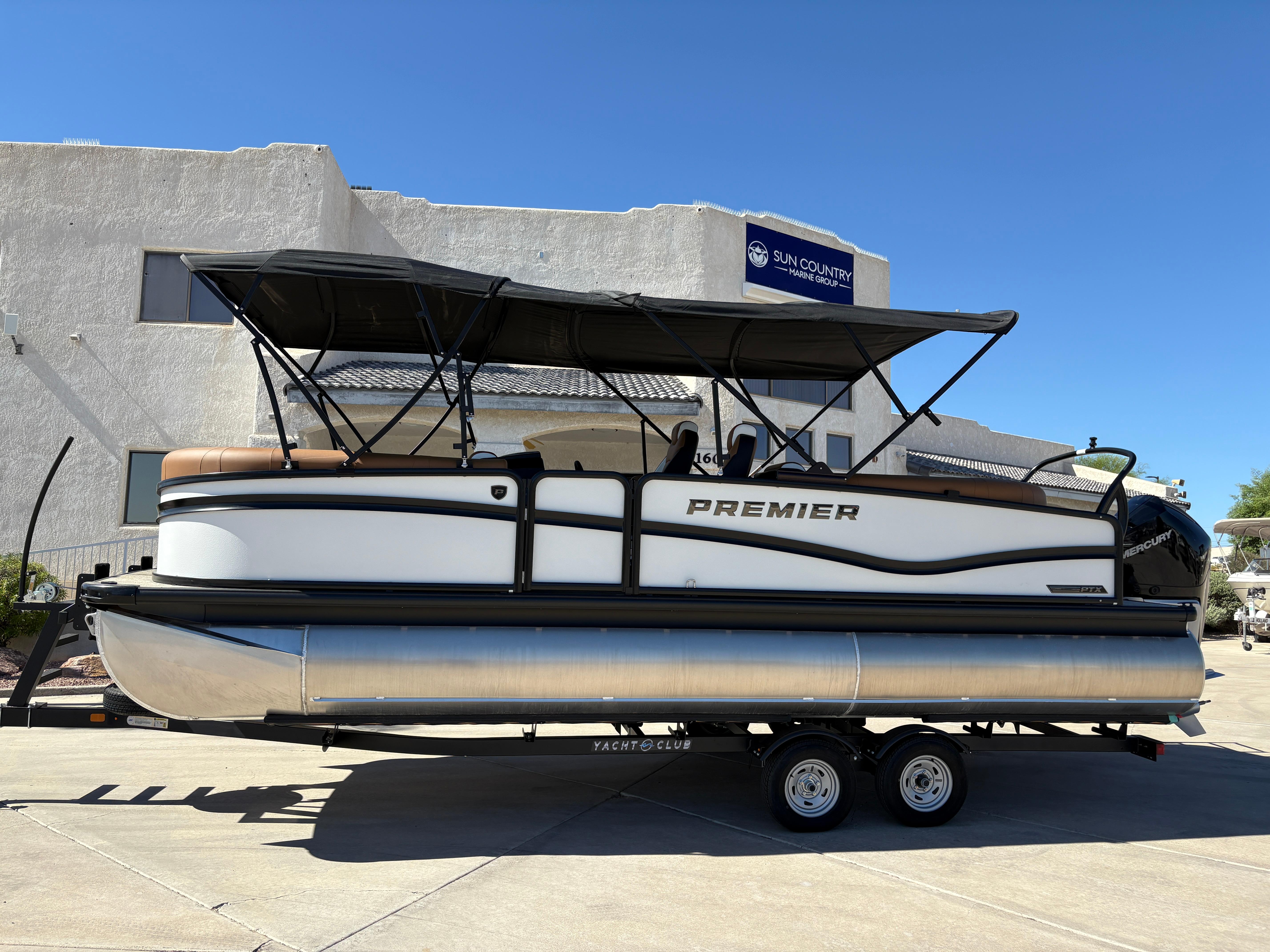 Premier 230 Solaris RF 2025 Premier 230 Solaris RF pontoon boat on trailer, parked outdoors.