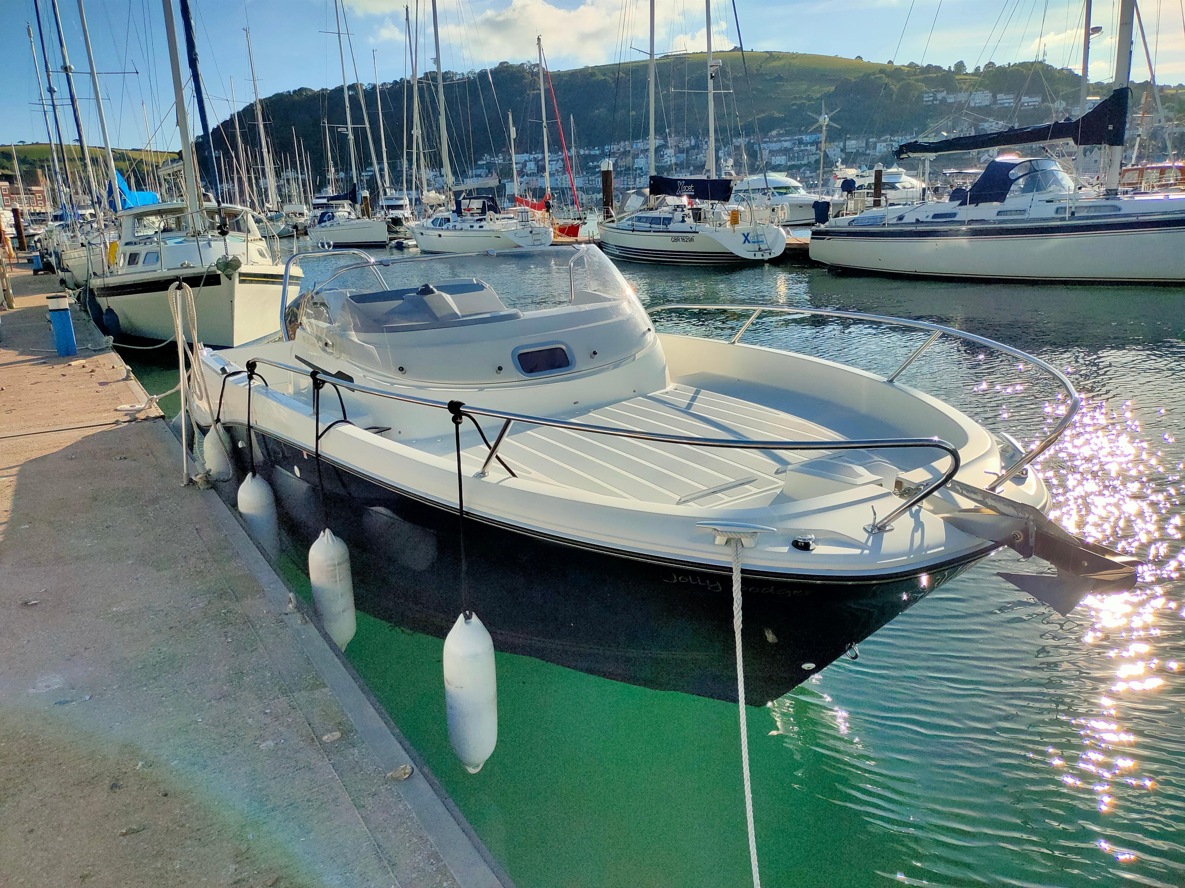 Jeanneau Cap Camarat 6.5 WA Series 3 2019 Jeanneau Cap Camarat 6.5 WA Series 3 docked in a marina, surrounded by sailboats.