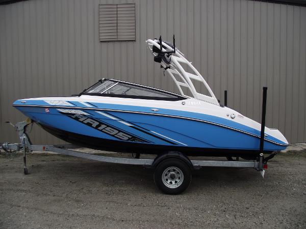 Yamaha Boats AR195 2021 Yamaha AR195 boat on trailer, blue and white design, parked outdoors.
