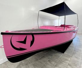 Vision Marine Technologies Fantail 217 2023 Vision Marine Technologies Fantail 217, pink electric boat with canopy, displayed indoors.