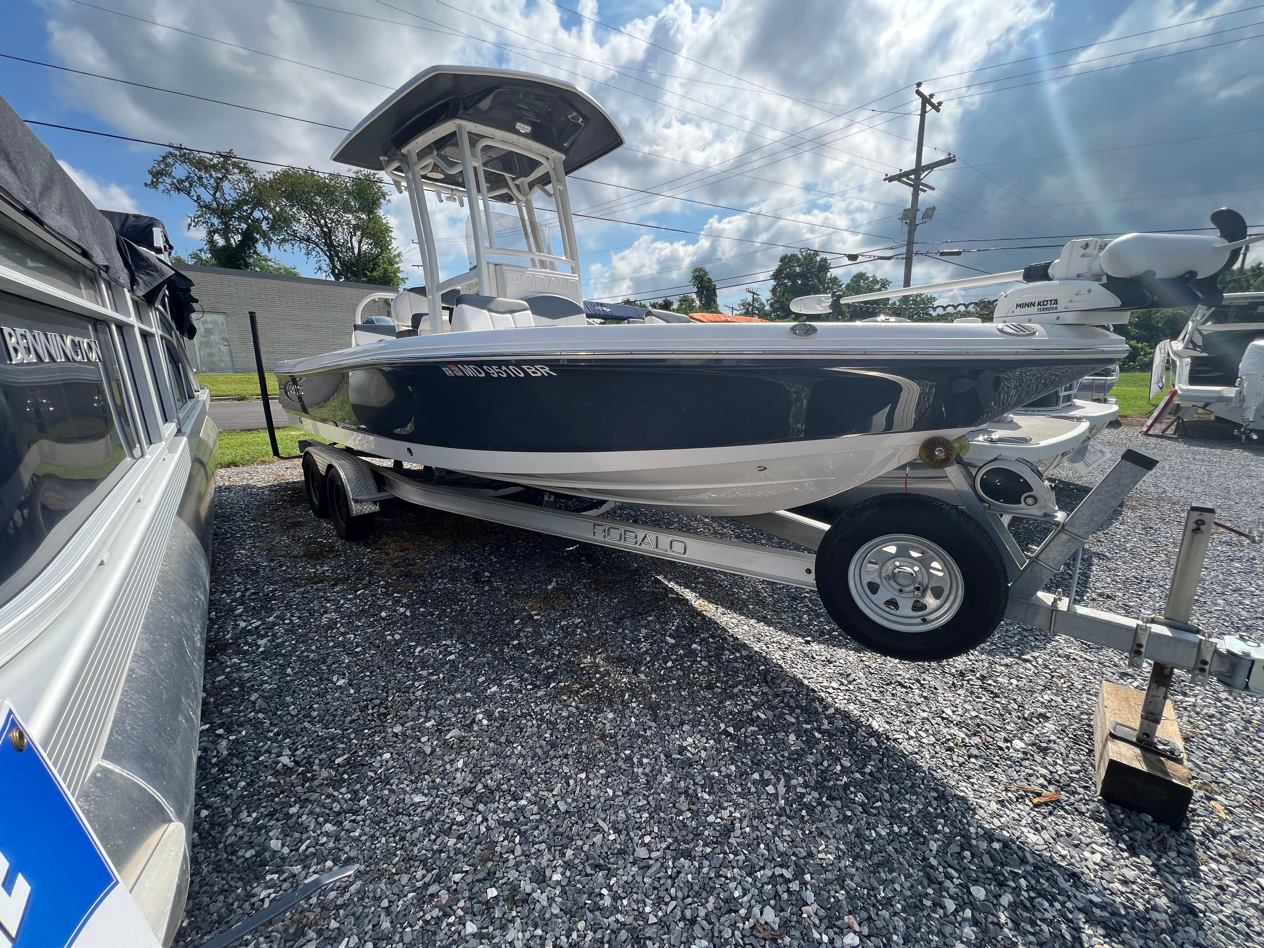 Robalo 226 Cayman 2021 Robalo 226 Cayman boat on trailer under cloudy sky.