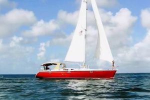 Beneteau Oceanis 50 Red 1991 Beneteau Oceanis 50 sailboat on open sea under clear skies.