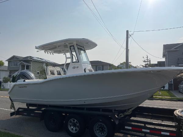 Tidewater 232 LXF 2025 Tidewater 232 LXF boat on trailer, parked in residential area.
