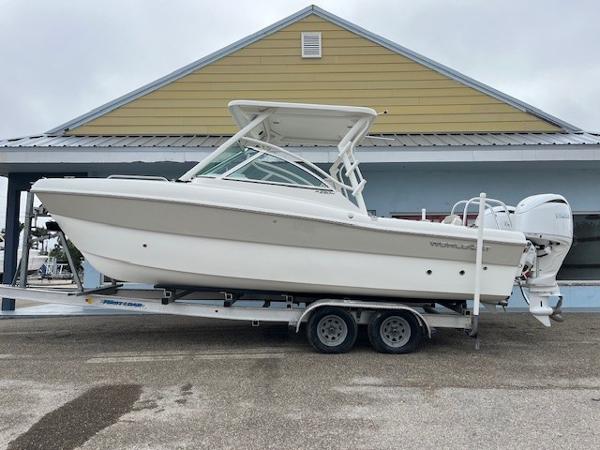 World Cat 230 DC 2025 World Cat 230 DC boat on trailer, parked outside a building.
